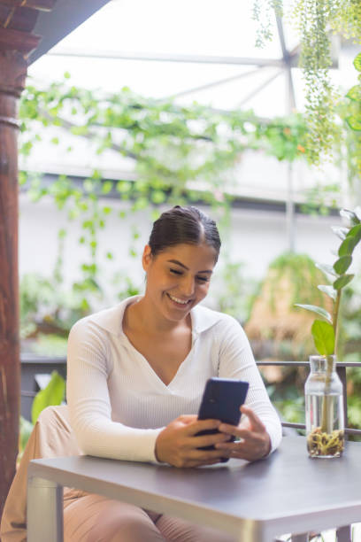 istock woman using her mobile in garden 1421101632