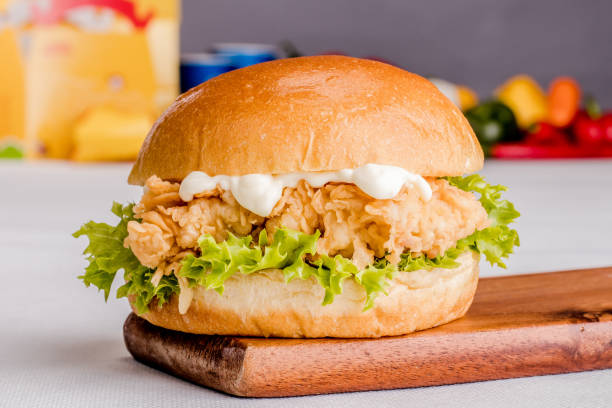 burger zinger classique repas isolé sur planche en bois vue latérale sur fond gris fastfood - chicken sandwich photos et images de collection