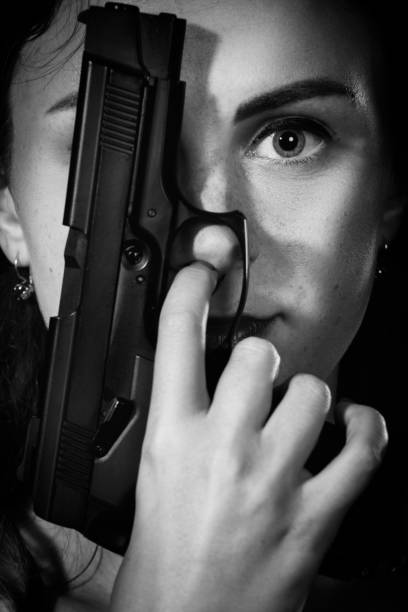 istock girl with gun 1421102889