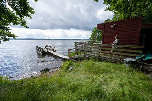 Alingsas, Sweden - July 02 2022: Small bathing platform and a sauna by a lake.