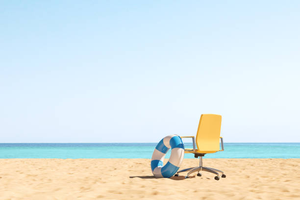 Office armchair and rubber ring on a beach, vacation. Copy space