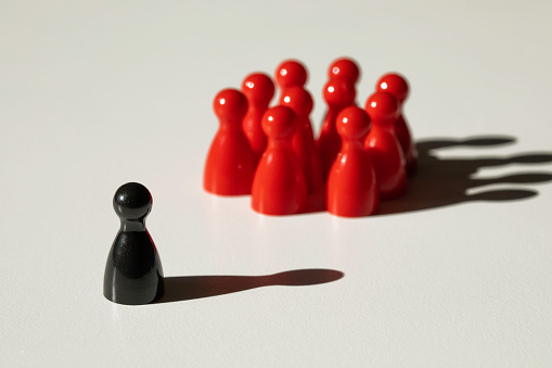 Black and red chess pieces over white background.