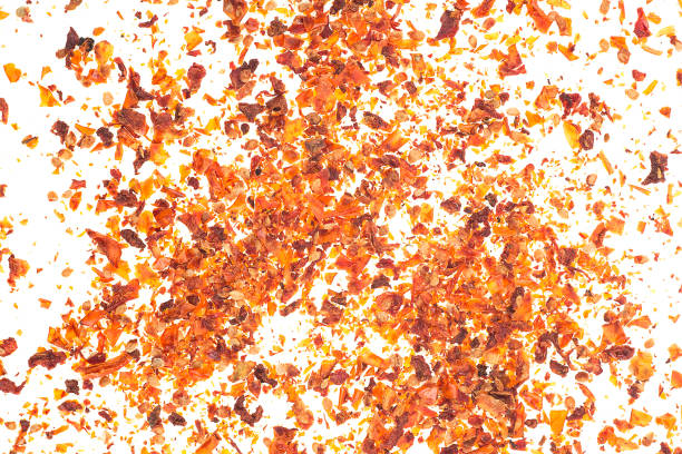 istock Dried tomato flakes as background, top view. Chopped tomatoes. 1421105302