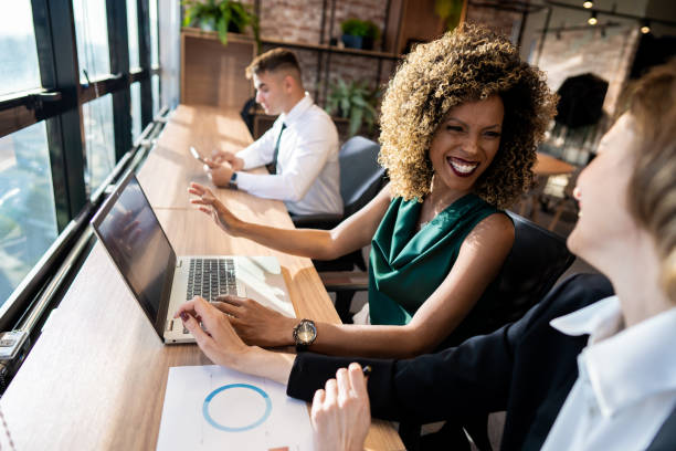 istock Coworkers in coworking space using laptop 1421106530