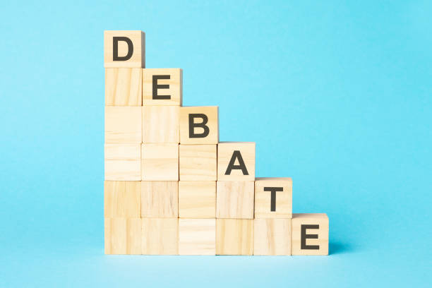 istock the word DEBATE is written on a wooden cubes, concept 1421108168
