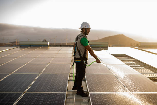 istock Cleaning solar panel early in the morning 1421108517