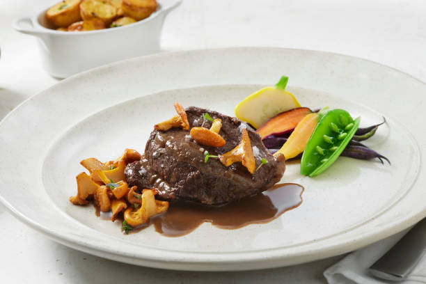 Red Wine Braised Beef Cheek Red Wine Braised Beef Cheek with Chanterelles, Garden Vegables and Madeira Jus madeira sauce stock pictures, royalty-free photos & images