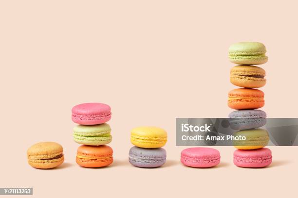 Stack And Diagram Of Macaroons As Coins Forming A Financial Graph On Beige Background Metaphors And Concept Stock Photo - Download Image Now