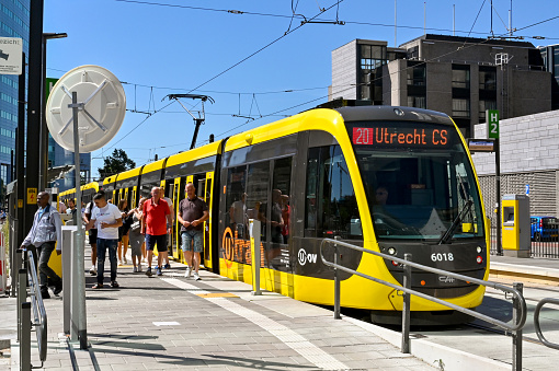 Utrecht, Netherlands - August 2022: People getting off a tram at a city centre stop