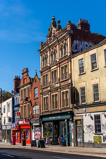 Bristol United Kingdom Cheltenham Road in the northern part of the city showing shops and apartment buildings. People are visible in the image