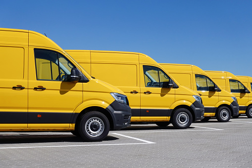 Yellow electric delivery vans in a row.