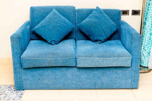 istock Brightly and classic suite, Hotel room with modern interior, blue couch, pillows. holiday relaxation vacation concept. Urban contemporary Interior design 1421118308