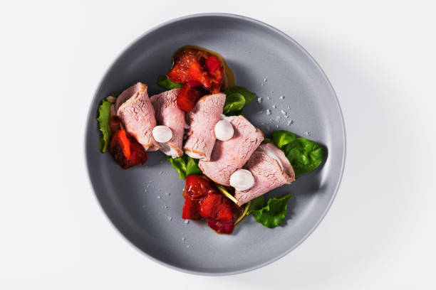 istock roast beef with sauce and sweet roasted peppers on white 1421120849