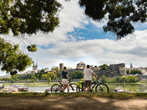 Cycling in France. Angers Chateau female cyclist in Angers, Loire Valley loire valley stock pictures, royalty-free photos & images