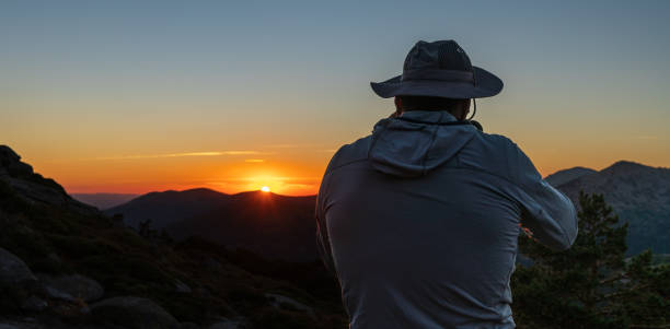 istock taking pictures of the sunset 1421123954