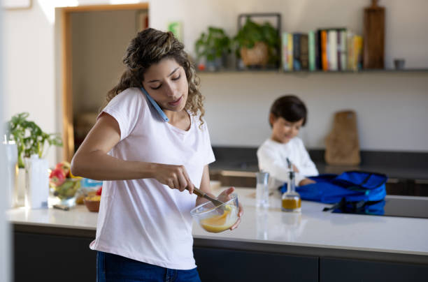 istock Busy mother getting her son ready for school 1421125357