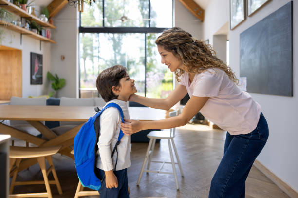 istock Mother saying goodbye to her son going to school 1421125380