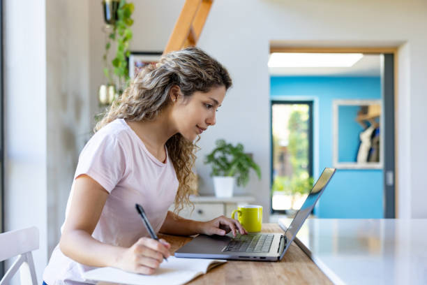 istock Young woman studying online from home 1421125504