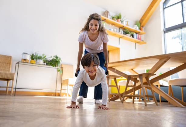 istock Happy mother and son having fun playing together at home 1421125544