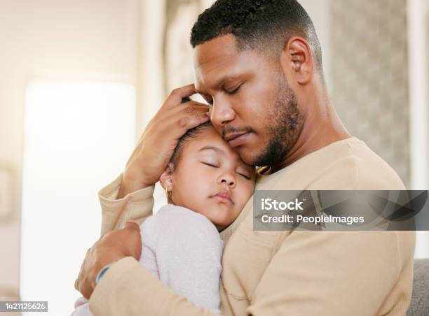 Father Hugging Sleeping Daughter Caring For Sick Child And Family Giving Loving Embrace At Home Girl Child Resting With Parent People Napping Together And Recovering From Sickness At House Stock Photo - Download Image Now