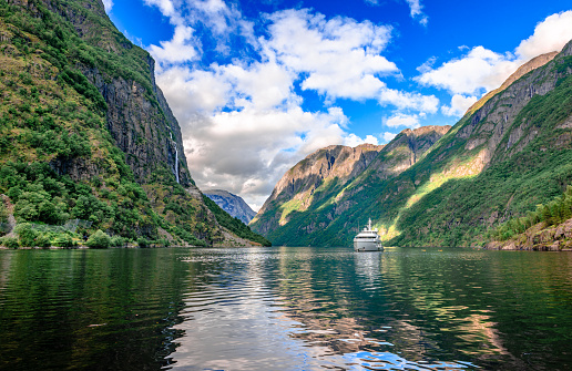 A tourboat sails in Aurlandsfjord, a branch off of the main Sognefjorden, Norway's longest fjord. Breathtaking Norwegian landscape.
