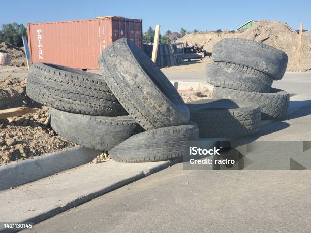 Pile Of Used Tires At A Large Construction Site Stock Photo - Download Image Now - Incomplete, Tire - Vehicle Part, Blue