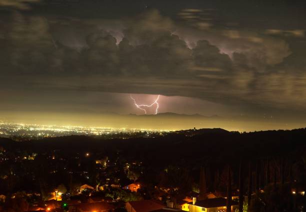 Lightning in the distance over the San Fernando valley Lightning Striking the San Gabriel Mountains above Los Angeles CA woodland hills los angeles stock pictures, royalty-free photos & images