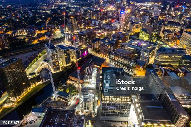 Manchester United Kingdom Aerial Shot Of Modern Buildings With Lots Of Counstruction In The Central Area Of The City With Historic Canals And Railways In The Foreground By Night Stock Photo - Download Image Now