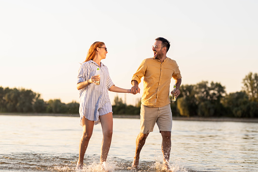 Young couple on summer day on the river, hugging and looking each other
Couple running threw the water
Summer time stock photo