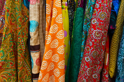 African Ghanaian colourful fabrics in a pile spread out on a table