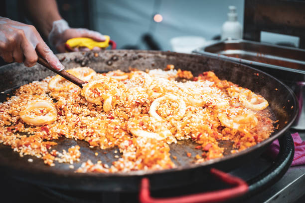 istock The man is cooking hot paella 1421136572