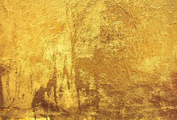 Photo of Gold texture. Golden Ore rocks. Rock texture. Stone background. Abstract texture. Shimmering surface. Precious Foil. Rough structure mineral.