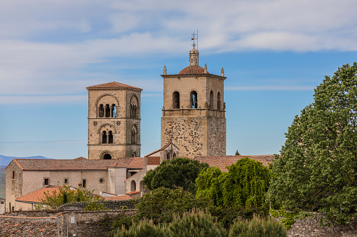 Trujillo, Spain - April 20th, 2022. Exterior of Santa María la Mayor church in Trujillo, Extremadura, Spain. It was originally built in Romanesque style in the 13th century and restored in Gothic style in the 16th century. The smaller Julia tower is the original which has been restored.