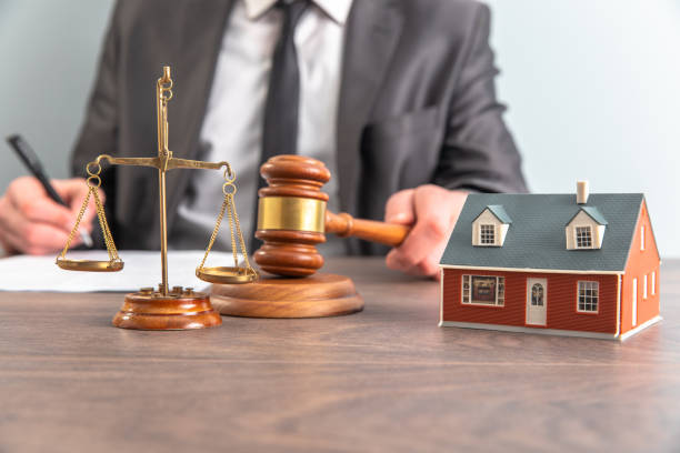istock Lawyer hands holding judge and house model 1421145527