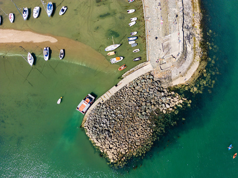 Aerial view of boats in a dry harbour at low tide (New Quay, Ceredigion, Wales)