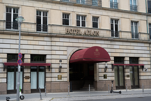 Berlin, Germany - June 19, 2022: An entrance (on Behrenstrasse) to the Hotel Adlon Kempinski Berlin, a luxury hotel.