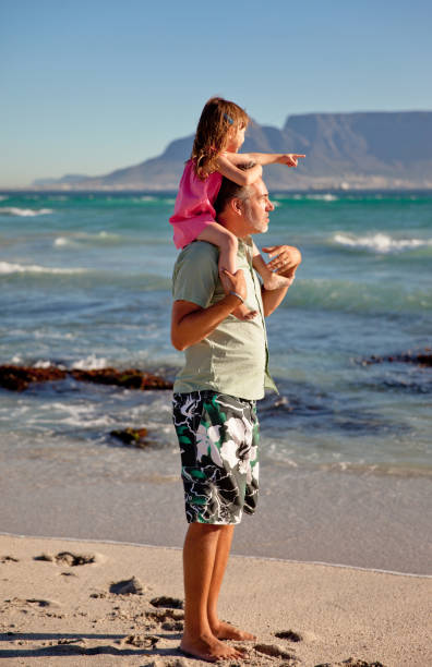 istock Father And Daughter Having Fun On The Beach - Stock Image 1421151407