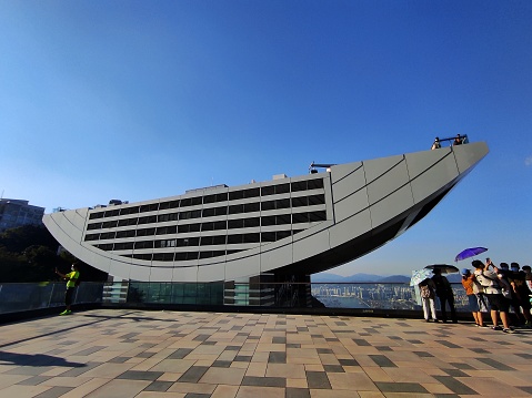 Hong Kong, September 4, 2022 : Tourists and locals around The Peak Tower. The Peak Tower is one of Hong Kong's most stylish architectural icons.