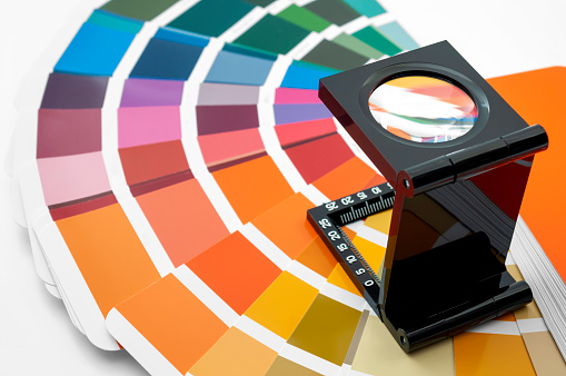 Printing loupe used to examine colour chart concept for color check, analyze quality of output colours of printing and magnifying colourful swatch