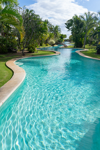 Swimming pool in the garden of an italian luxury villa, sunny day     