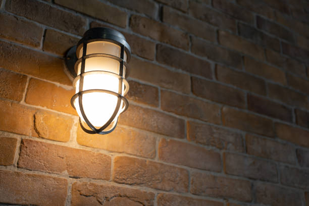 istock Incandescent bulb that illuminates on the brick wall. 1421163657