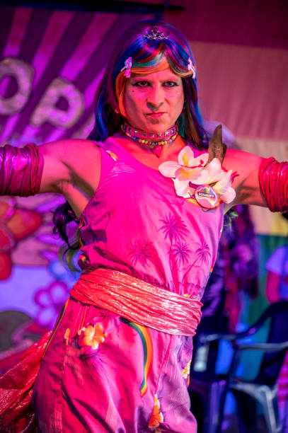 Lismore, NSW: August 28, 2022.\nMan in drag dances at a Gay fair day.\nLGBTQIA + is an initialism that stands for lesbian, gay, bisexual, and transgender. In use since the 1990s, the initialism, as well as some of its common variants, functions as an umbrella term for sexuality and gender identity. This community in Lismore NSW calls itself Tropical Fruits and has a number of celebrations throughout the year. This event happened after three years of cancellation due to covid and the worse floods in history. It is a free, largely outdoor event which involves dressing up and having a dog show.
