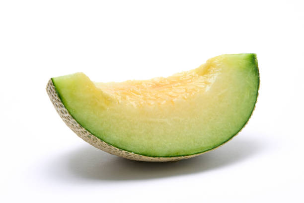 istock Earl's melon cut in quarters, photographed against a white background 1421169549