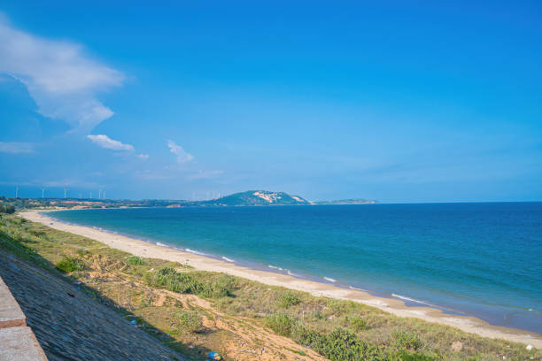 istock Panoramic coastal Mui Ne view from above, with waves, coastline, streets, coconut trees. Phan Thiet 1421172107