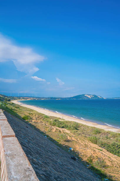 istock Panoramic coastal Mui Ne view from above, with waves, coastline, streets, coconut trees. Phan Thiet 1421172122