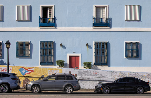 Street view of a residential building behind a colorfully painted wall, Old San Juan, Puerto Rico