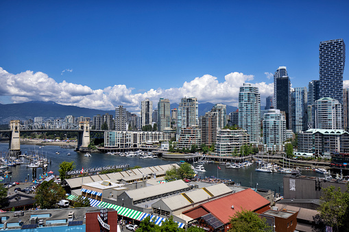 Vancouver, Canada - Circa 2021 : Downtown Vancouver with snowy mountain background