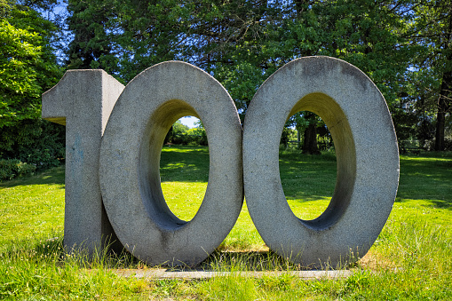 No. 100 sign made by concrete in a park in Vancouver.