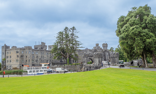 Cong, Ireland - July 9, 2022: Ashford Castle is a medieval and Victorian castle that has been expanded over the centuries and turned into a five-star luxury hotel near Cong on the Mayo-Galway border in Ireland.