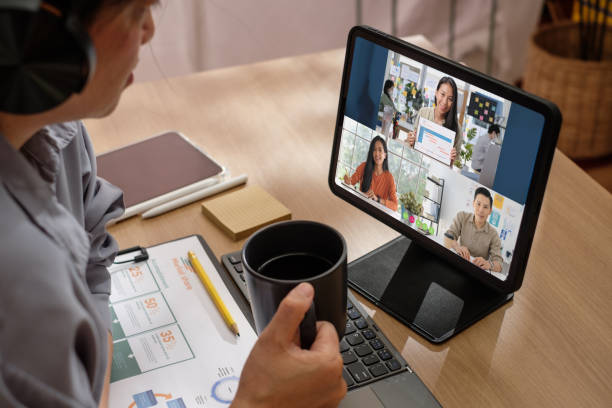 asian woman video conference business meeting with colleague online with tablet at home stock photo